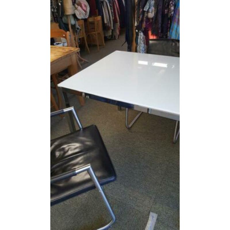 Tafel met wit glazen blad en RVS onderstel